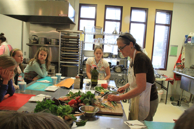 The Wellness Kitchen volunteer Terri Knowlton teaches cooking classes for children twice a month at the nonprofit's Templeton location. Photo by Heather Young