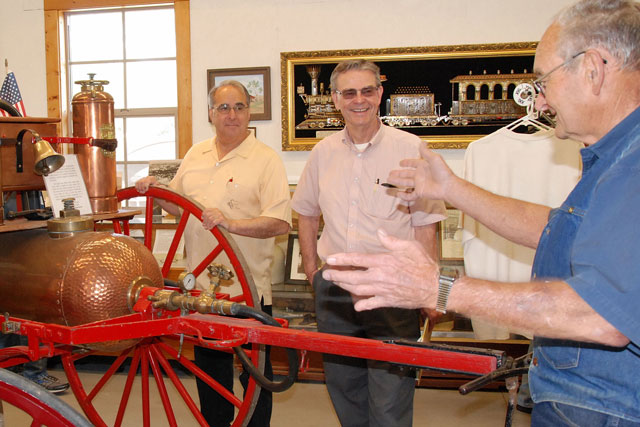 Atascadero Mayor Tom O’Malley, at left,  and Paso Robles Mayor Steve Martin, center, listen as Daryl Radford describes the antique fire wagon displayed in the restored Templeton Train Depot. Martin and O'Malley support many local activities jointly and refer to themselves as “Dos Alcaldes”, Spanish for “two mayors." They even have their own website at www.DosAlcaldes.com. 