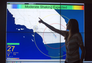 Maren Boese, a research fellow at Caltech, demonstrating an earthquake simulation along the San Andreas Fault (photo: NY Times)