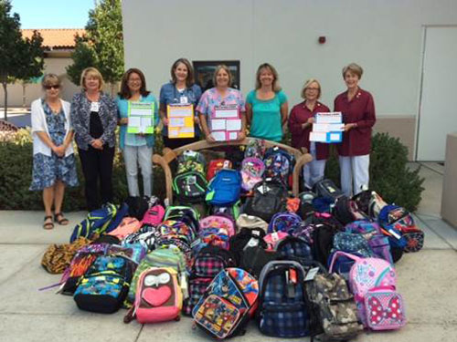From left, Twin Cities Community Hospital staff Lola McClintock, Kathleen Juvet, RN, Tricia Hammond, Chelle Newman, RN, Cyndi Allan, RN, Margie Hienen, RN, Carla Young, and Doreen Bird with the 60 backpacks stuffed with school supplies that will be donated to underprivileged children in the North County.