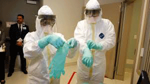 Ebola care workers donn protective gear before caring for a patient. Photo courtesy of the CDC