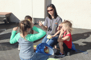 A Cal Poly nutrition senior plays a game with children at the Paso Robles Boys & Girls Club at the first kids' farmers' market on Friday, Oct. 24. Photo by Heather Young