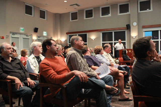 Paso Robles resident Steve Rath, standing behind the lecturn in white, represents his neighborhood at the Oct. 21 meeting. The majority of the people in attendance were from the neighborhood. Photo by Heather Young