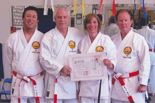 Karate Kyoshi 7th Dan Art Garcia, Kyoshi 8th Dan Nabil Noujaim, Renshi 5th Dan Michelle Rogers and Kyoshi 7th Dan David Rogers stand together after Michelle was promoted to Godan in 2012.