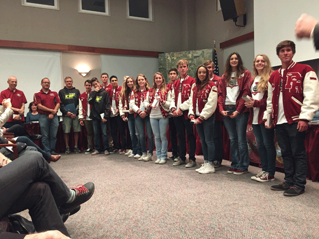 The Paso Robles High School varsity boys and girls cross country team lines up at the front of the city council meeting on Jan. 20 after the council presented the coaches and team members with personlized medals recognizing the team's performance at state. Photo by Heather Young