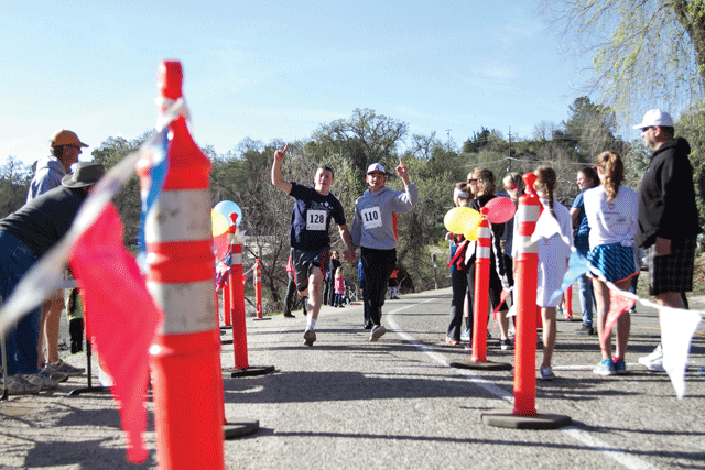 Two runners cross the finish line at the 2014 Hares N Hounds 5K and Fun Run. Photo courtesy of Atascadero Greyhound Foundation