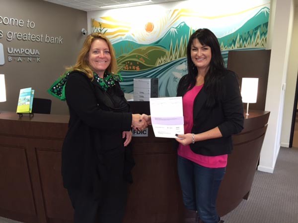 Umpqua Bank's Assistant Vice President of the Central Coast Agriguclture and Commercial Banking Center Ashley Ogden presents the donation to Manager of Community Engagement for Girl Scouts of California's Central Coast  Laura Romano.