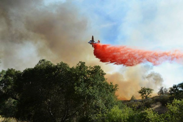 A tanker plane drops a load of fire retardant over the Park Hill Fire. Photo by Trisha Butcher.