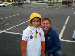 Up With Kids committee member Darryl Stolz stands with a child after he goes shopping after a past event.
