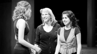 Catherine Kingsbury works with two student actors onstage.