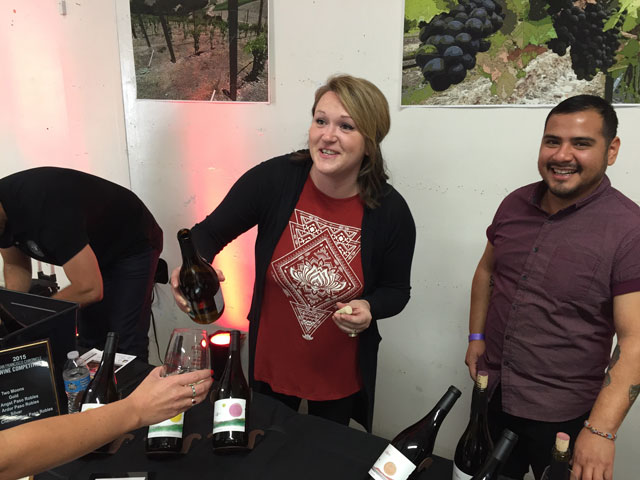 Amber Bierwirth and Daniel Boone pour wine from Moon Cellars, a wine label from Clavo Cellars in Templeton.