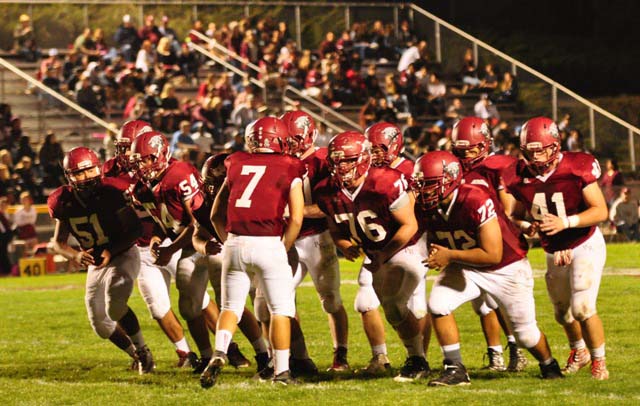 Quarterback Justin Davis, center, calls out the plays during Paso Robles' 30-0 shut-out win over Righetti last week. Davis and his fellow Paso Robles High School Bearcats will host the rival Atascadero Greyhounds on Friday, Nov.  6 at War Memorial Stadium. JV action starts at 4 p.m., with the Varsity players taking the field at 7 p.m. Photo by Meagan Friberg