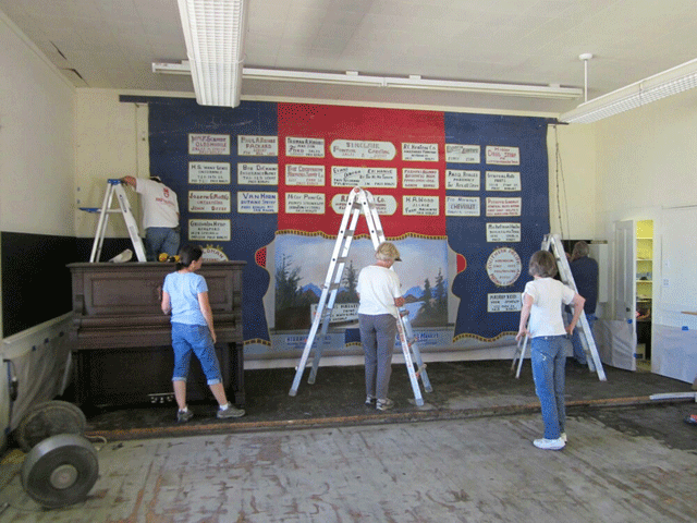 Volunteers work inside the Pleasant Valley Community Foundation's 1908 schoolhouse that it is rehabbing.