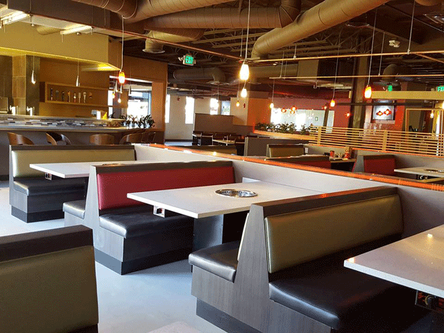 Each table has a grill for individual cooking.