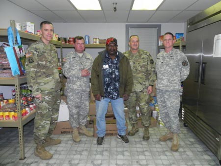 Monterey County Veterans Transition Center, Dec. 17. The VTC Volunteer Coordinator, Parnell Strickland, pictured with the Fort Hunter Liggett Commander, Jan C. Norris (left), some of his staff and more than a thousand pounds of food donated by its military and civilian workforce of FHL. Parnell is an Army veterans who served with the 7th Infantry Division at Fort Ord, Calif. "The VTC has changed my life, and helped me become the man I am now, a proud veteran."