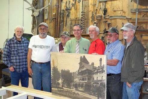 Paso Robles Mayor Steve Martin poses with the Pioneer Museum team working on a scale model representation of a portion of the front of the original Paso Robles Inn.