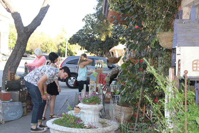 Atascadero Art & Wine Tour attendees check out the wares outside Rhonda's Relics on Friday. Photo by Heather Young