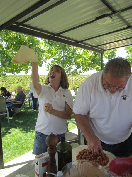 It was pizza time at Eberle winery at the Sunday open house. Marcy Eberle tossed the pizzas as Gary assembled.