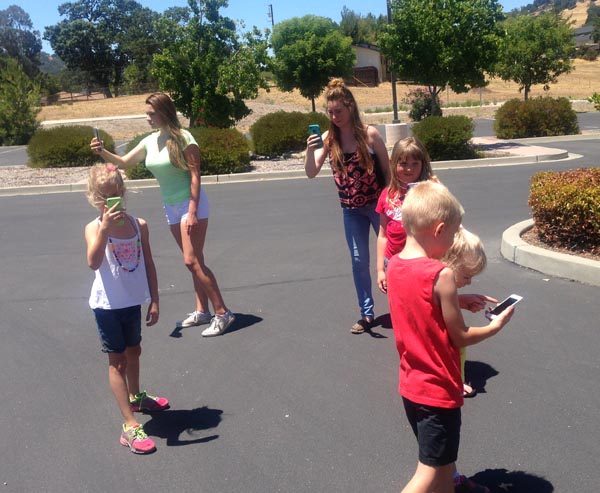 Local children playing the Pokemon Go game. 