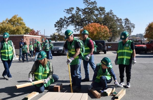 Students prepare to lift and crib a collapsed wall in order to rescue a trapped victim