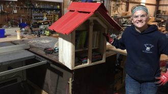 Hannah Bourgault completes a tiny library for elementary students
