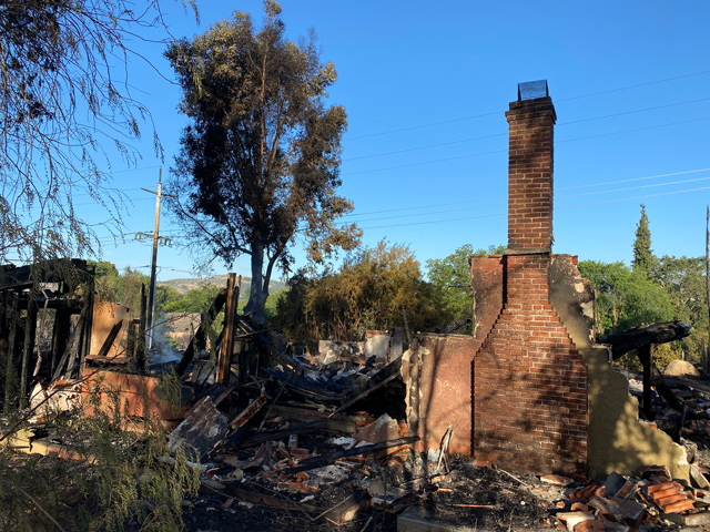 The remains of a home smoldering Tuesday morning at Capitol Hill Drive and Creston Road in Paso Robles