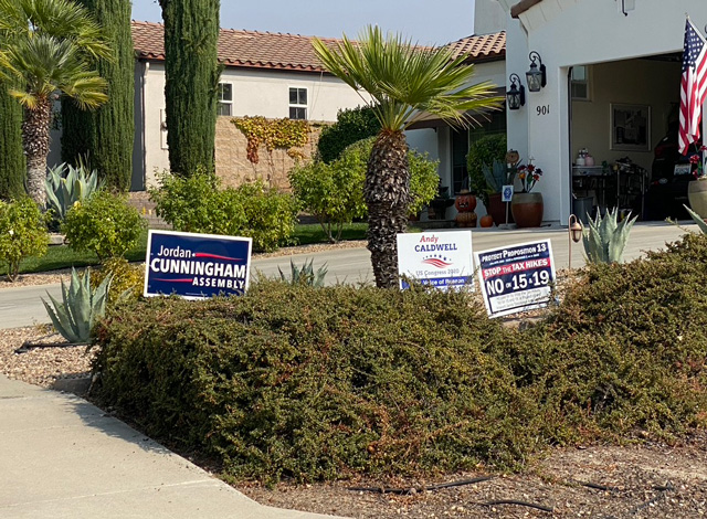 Signs supporting Jordan Cunningham for Assembly, Andy Caldwell for US Congress, and "No on 15"