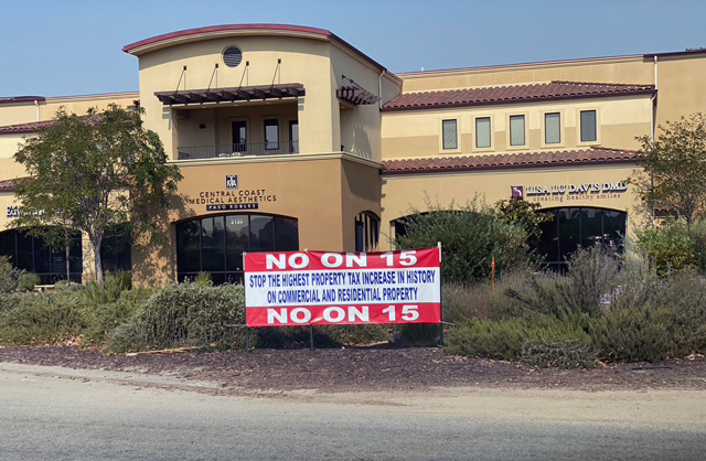 sign urges voters to vote "No on 15", a proposition that increases property taxes
