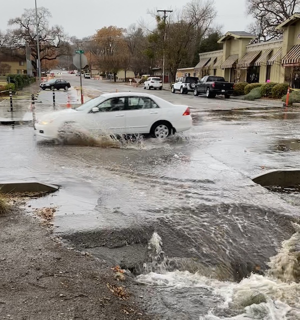 Water drains down 7th Street at Pine Street on Monday morning.