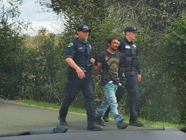 Police escort a robbery suspect near the Salinas Riverbed on Friday afternoon. Photo by Brandon Stier.