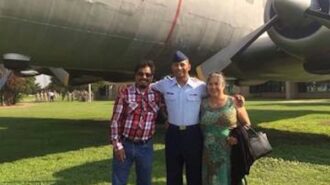 Mrs. Juana Flores and her husband with their son, Sgt. Caesar Flores of the United States Air Force