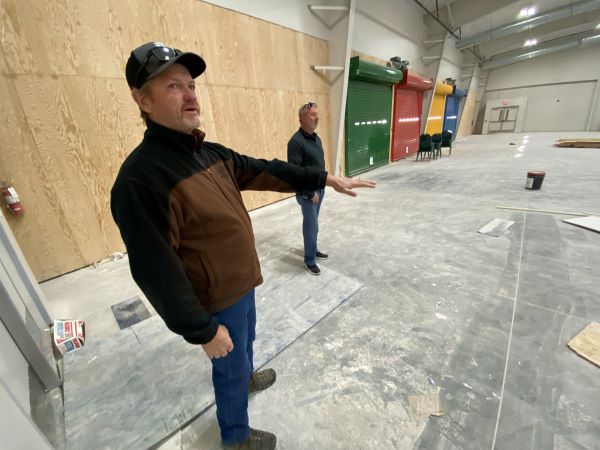 Bourgault and contractor look at unfinished gym