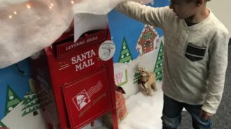 Child Mailing Letter to Santa at Centennial Park