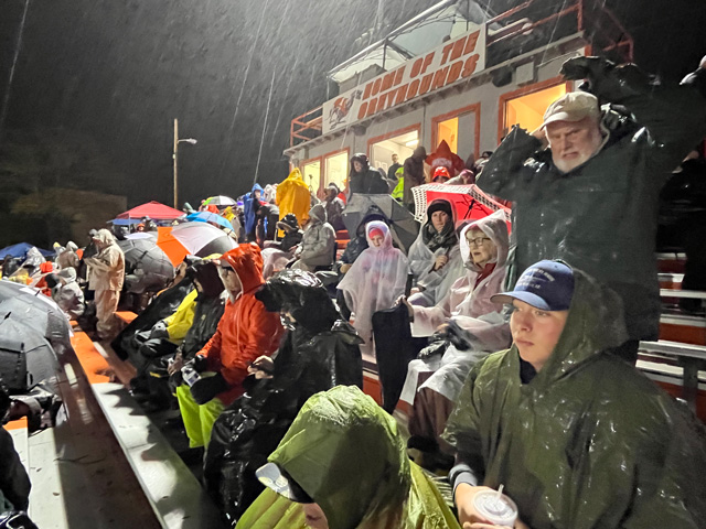The crowd, drenched in rain, awaits the kickoff