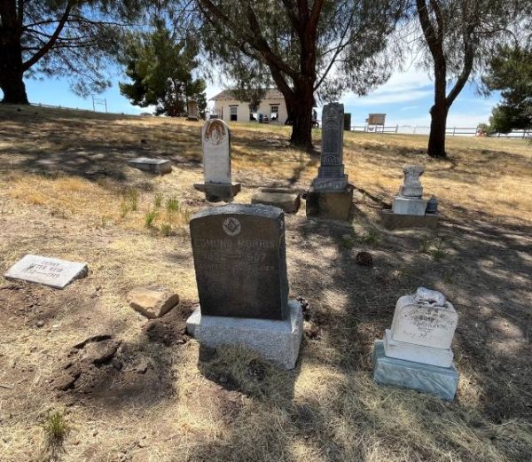 Graves with adobe in distance