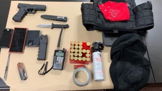 Police search finds weapons, stab-resistant vest, police scanner