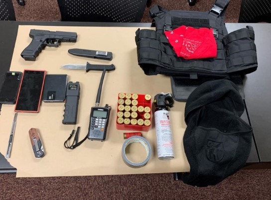 Police search finds weapons, stab-resistant vest, police scanner